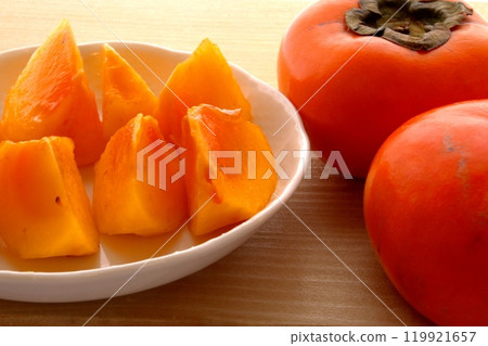 Cut persimmon and persimmon fruit Cut persimmon and persimmon fruit 119921657