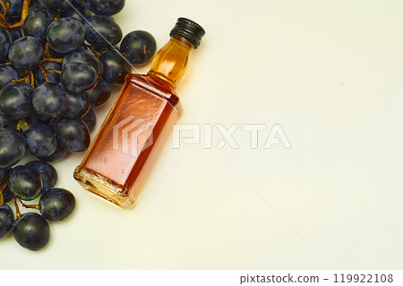 Relax. Good old brandy cognac and black ripe grapes and on white Relax. Good old brandy cognac and black ripe grapes and on white 119922108