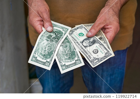 Human male hands holding small dollar bills.Paper money,currency Human male hands holding small dollar bills.Paper money,currency 119922714