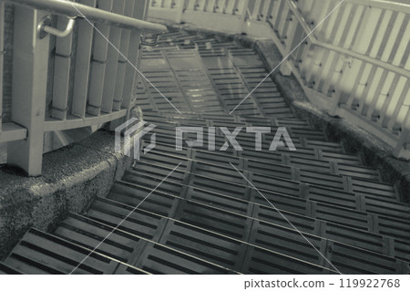 Monochrome photo: Descending stairs of a footbridge 119922768