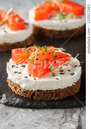 Smoked Salmon cheesecake breakfast sandwich toast closeup on slate plate. Vertical Smoked Salmon cheesecake breakfast sandwich toast closeup on slate plate. Vertical 119922865
