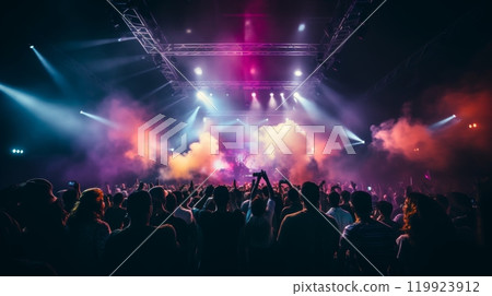 Rear view of a full concert hall with crowded spectators, fans dancing and cheering in excitement 119923912