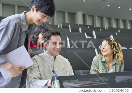 Group of multinational students having a conversation in a classroom 119924002