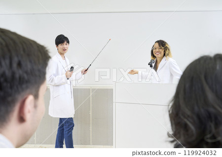 A multinational group presenting research in a classroom 119924032