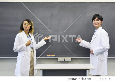 Multinational group giving a lecture in a classroom Multinational group giving a lecture in a classroom 119924050