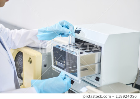 Foreign female scientist using laboratory equipment 119924056