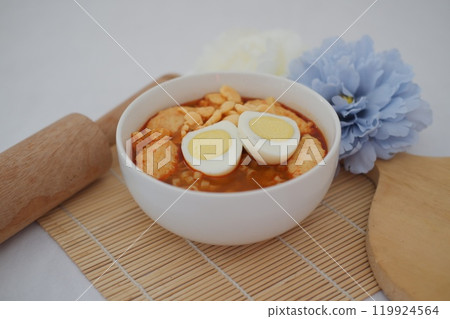 spicy egg noodle soup with crackers 119924564