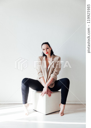 Beautiful plump brunette woman in a business suit Beautiful plump brunette woman in a business suit 119925985