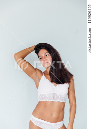 Beautiful brunette woman in lingerie in bedroom on bed after sleep 119926595