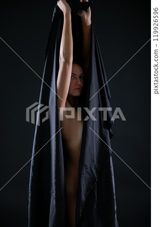 Beautiful brunette woman in black lingerie on gray background Beautiful brunette woman in black lingerie on gray background 119926596