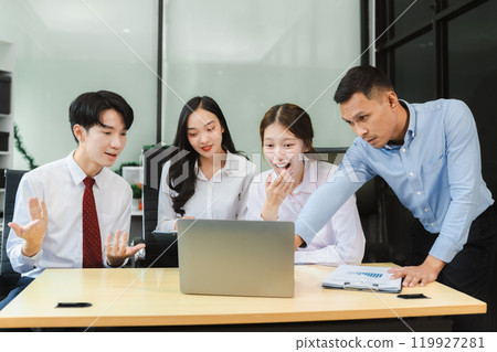 Business team working on a project in the office or reviewing and discussing a business project. Business team working on a project in the office or reviewing and discussing a business project. 119927281