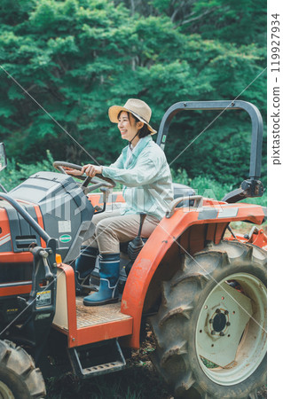 Woman driving a tractor Woman driving a tractor 119927934