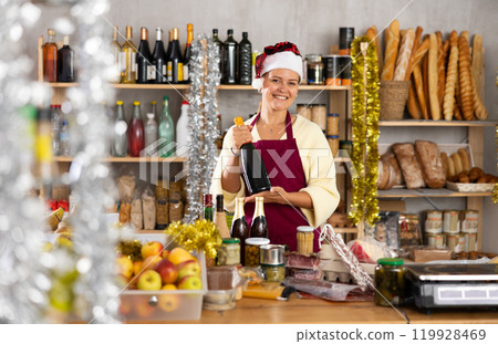 Woman seller in Santa Claus hat with food 119928469