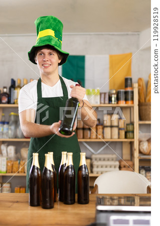 Young male seller offers beer and whiskey 119928519