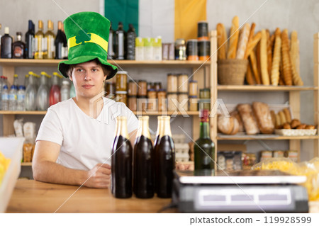 Young male seller offers beer and whiskey 119928599