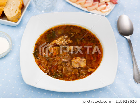 Borsch in bowl on table with salo and smetana 119928626