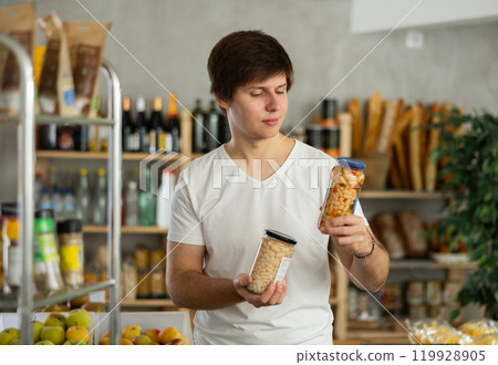 Young man choosing beans in grocery store Young man choosing beans in grocery store 119928905