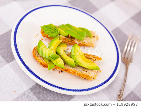 Avocado sandwich served on table 119928958