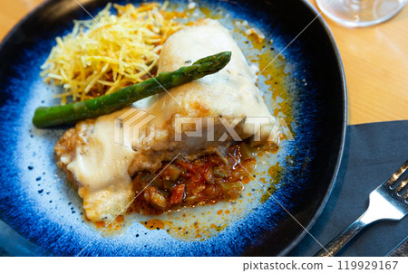 Cod fillet in aioli with ratatouille and fried potato straw 119929167