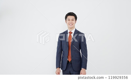 Asian businessman standing with a smile Asian businessman standing with a smile 119929356