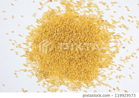 Macro scattered bulgur cracked wheat on a white background Macro scattered bulgur cracked wheat on a white background 119929573