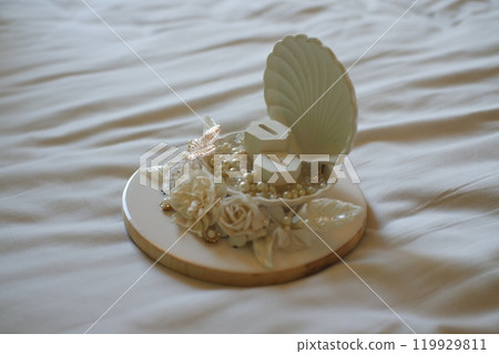 Elegant Wedding Ring Holder with Floral Decorations Elegant Wedding Ring Holder with Floral Decorations 119929811