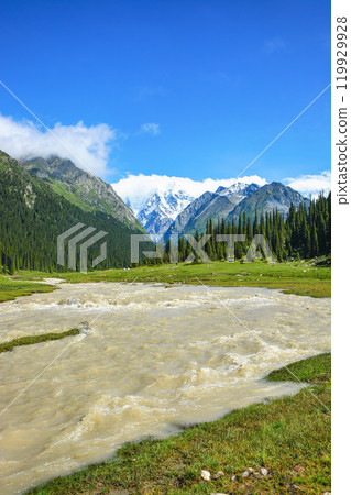 Idyllic summer landscape with hiking trail in the mountains with beautiful fresh green mountain pastures, river with reflection and forest. Terskey Alatoo mountains, Tian-Shan, Jeti-Oguz, Kyrgyzstan Idyllic summer landscape with hiking trail in the mountains with beautiful fresh green mountain pastures, river with reflection and forest. Terskey Alatoo mountains, Tian-Shan, Jeti-Oguz, Kyrgyzstan 119929928