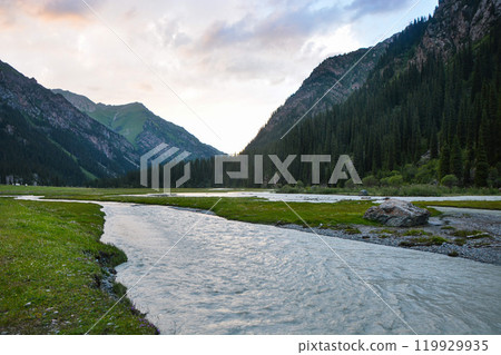 Idyllic summer landscape with hiking trail in the mountains with beautiful fresh green mountain pastures, river with reflection and forest. Terskey Alatoo mountains, Tian-Shan, Karakol, Kyrgyzstan 119929935