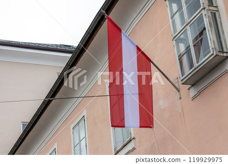 Austrian flag on a building in the city of Salzburg in the Alps. Austrian flag on a building in the city of Salzburg in the Alps. 119929975