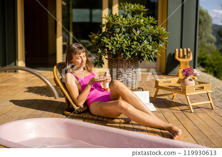 Relaxation with Sunscreen on a Wooden Deck 119930613