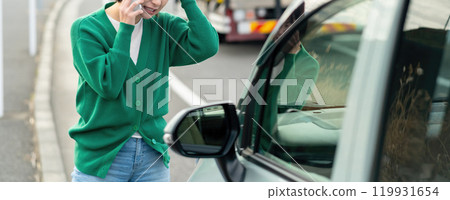 Woman calling about car trouble Woman in trouble after car accident 119931654