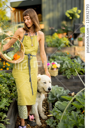 Woman with her dog in eco-friendly garden 119932793