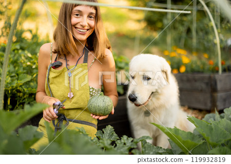 Woman with her dog in eco-friendly garden Woman with her dog in eco-friendly garden 119932819