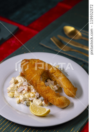 Traditional Christmas dinner in Czech Republic - fried carp with potato salad Traditional Christmas dinner in Czech Republic - fried carp with potato salad 119932872