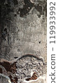 Close-up of textured concrete surface with cracks and peeling paint. 119933992