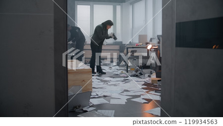 Investigation team working at crime scene: Male detective enters the room 119934563