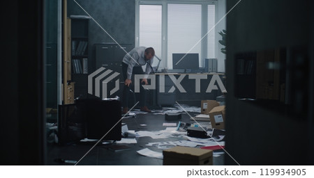 Aggressive businessman in fit of rage yells and destroys office room 119934905