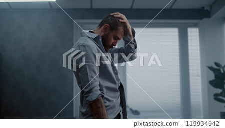 Stressed businessman stands, breathes heavily after destroying office room Stressed businessman stands, breathes heavily after destroying office room 119934942