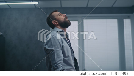Nervous businessman sits down on floor after destroying office due to failed business deal Nervous businessman sits down on floor after destroying office due to failed business deal 119934951