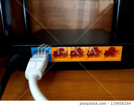 A Wi-Fi router is connected to the internet and power supply. 119936284