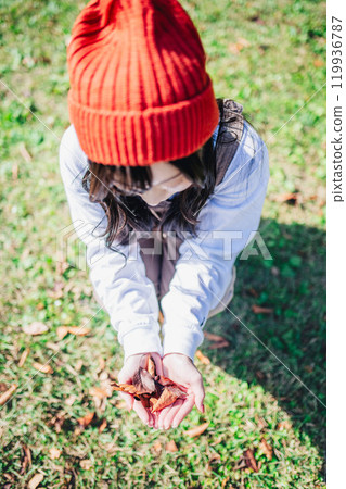 Young woman searching for autumn at campsite Young woman searching for autumn at campsite 119936787