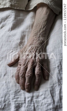 Old hand resting symbolizing age and resilience 119937247