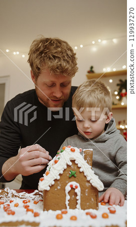 Father and Child Bonding Over Gingerbread House 119937270