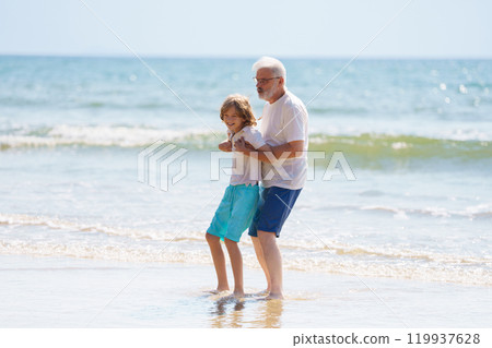 Grandfather and kids on summer beach 119937628