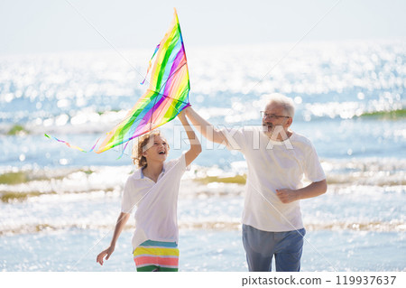 Grandfather and kids play on summer beach Grandfather and kids play on summer beach 119937637