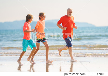 Grandfather and kids on summer beach Grandfather and kids on summer beach 119937806