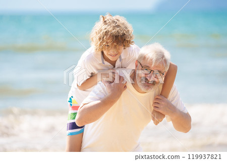 Grandfather and kids on summer beach 119937821