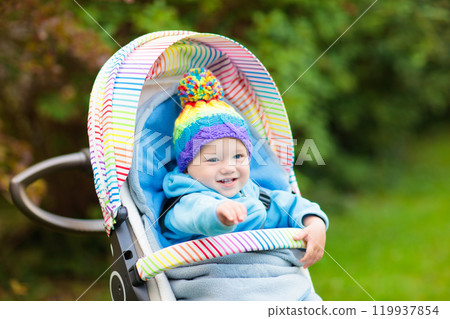 Baby boy in stroller in autumn park 119937854