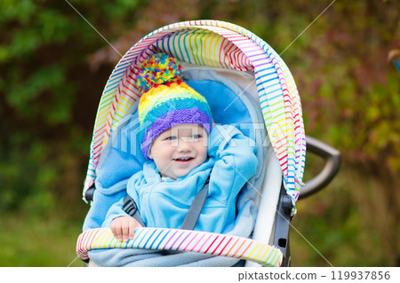 Baby boy in stroller in autumn park 119937856