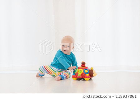Baby boy playing with toy 119937861